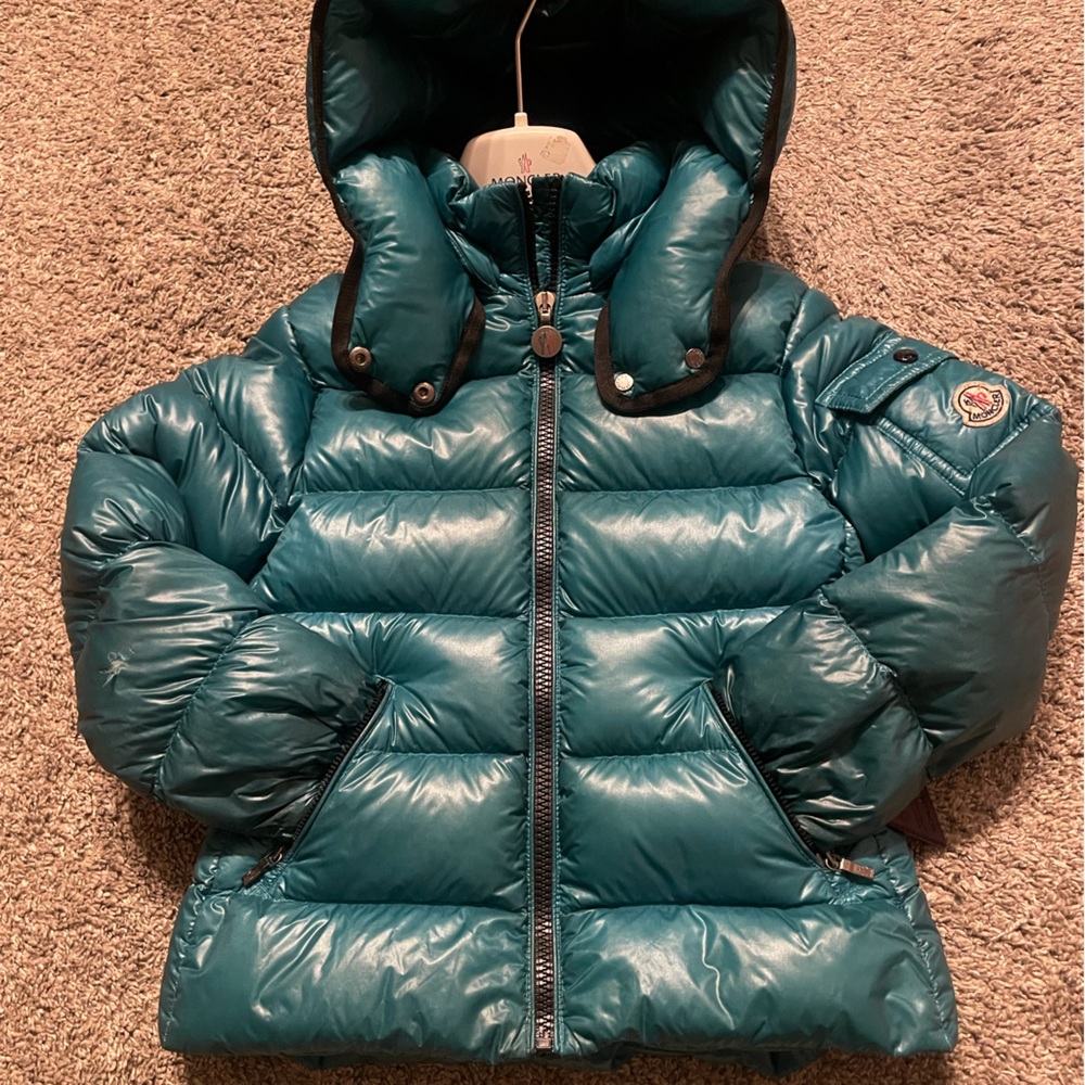 Moncler coat turquoise has a small hole can be fixed